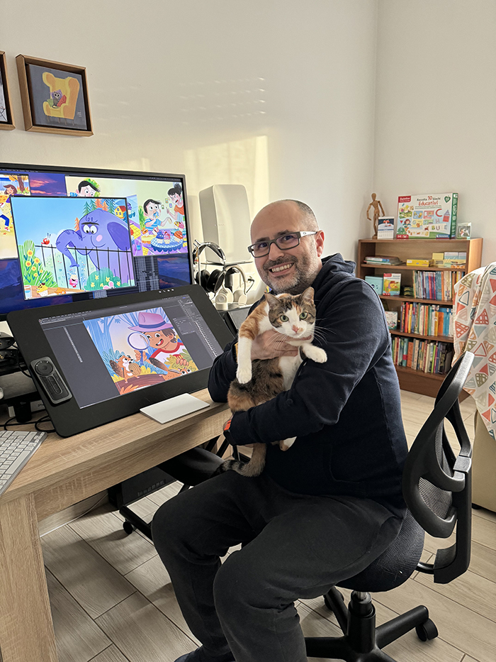 Claudio Cerri in his illustration studio, holding his cat
